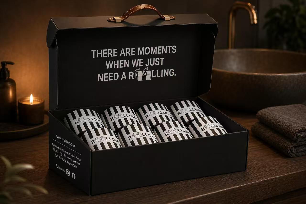 Original AI packaging concept showing a black gift box with carry handle and bamboo toilet paper