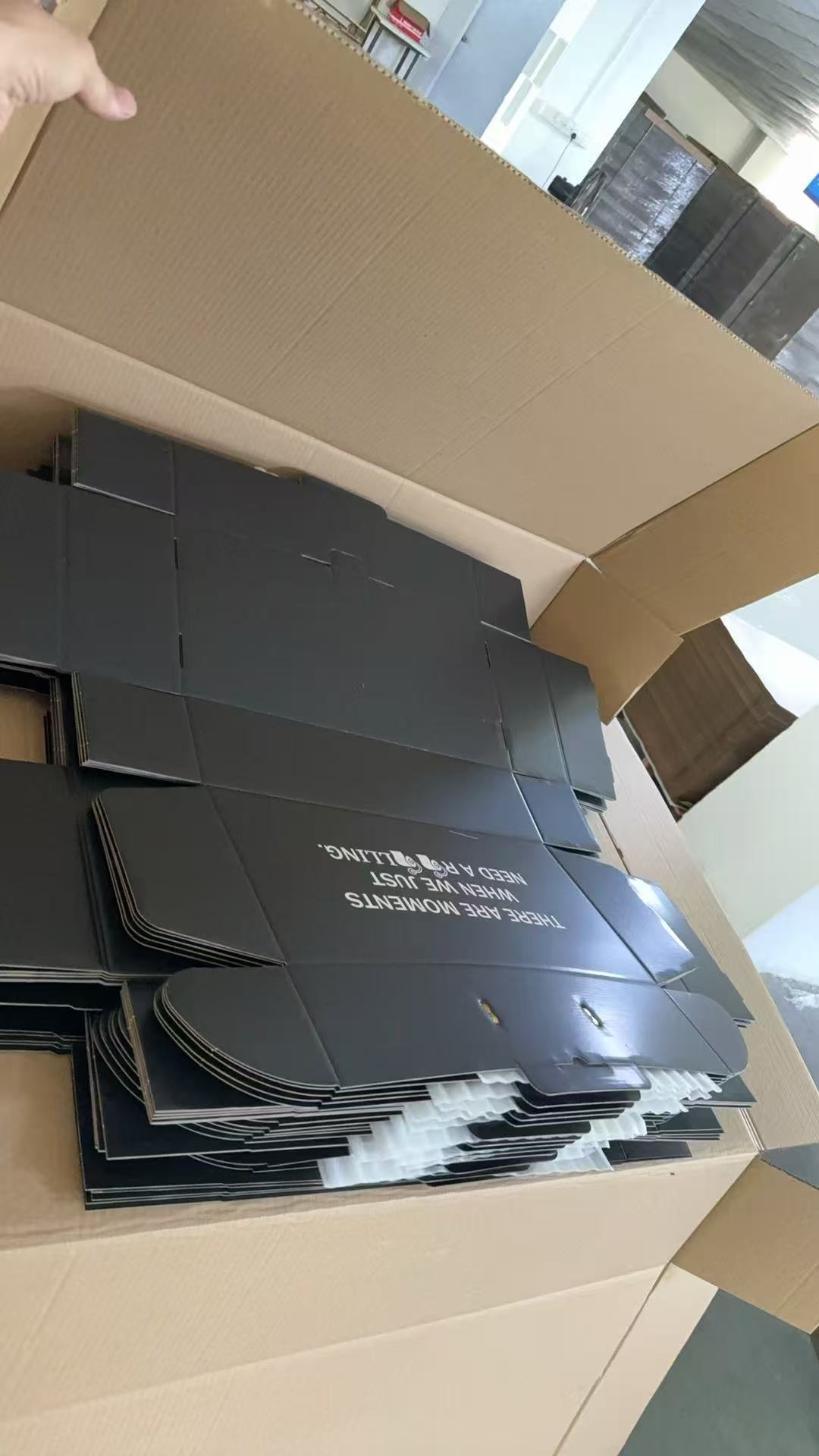 Stacks of printed corrugated gift mailer components prepared for production