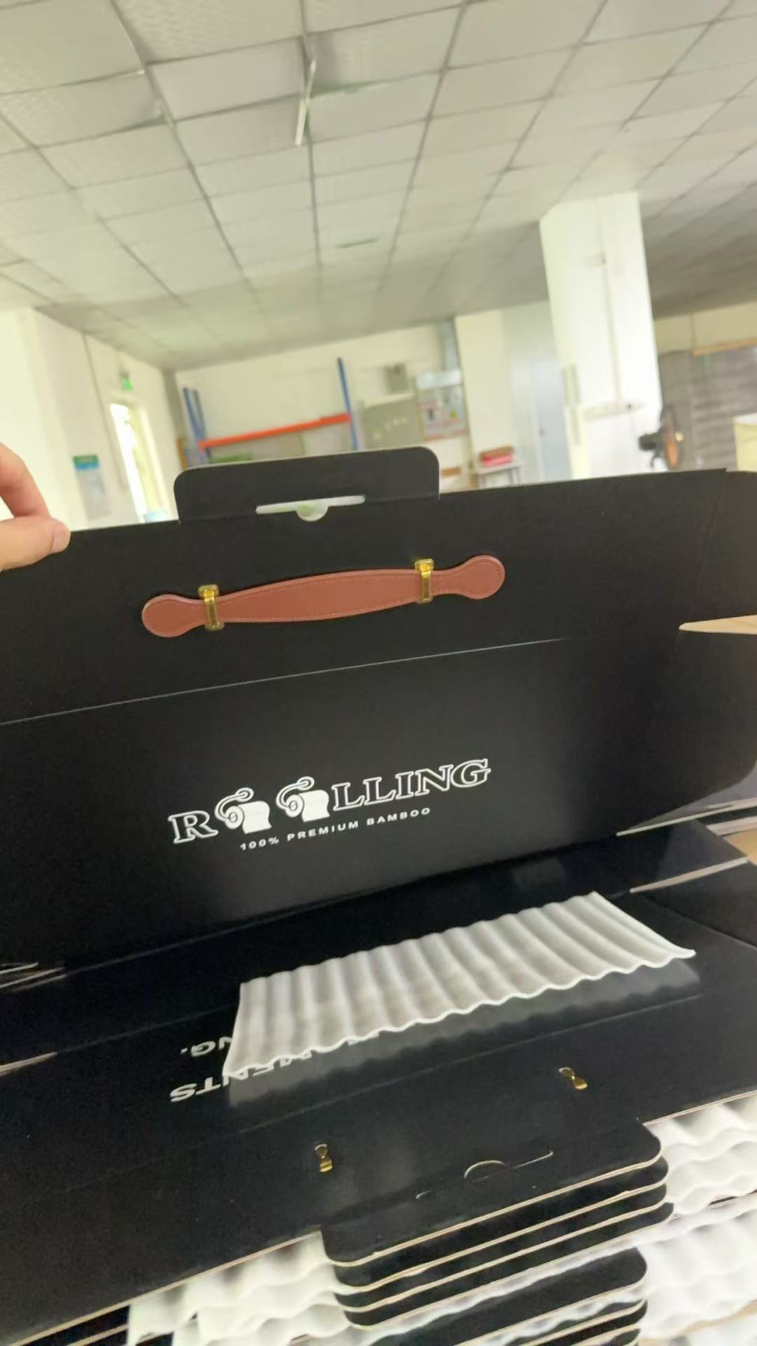 Corrugated gift box sample with a brown PU handle and metal fittings